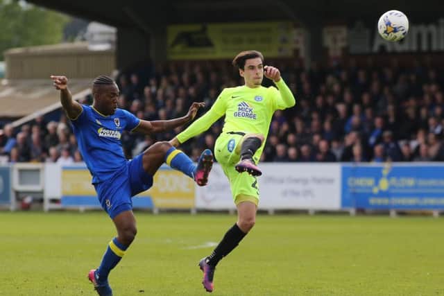 Callum Chettle of Posh switches play under pressure from Wimbledon substitute Dom Poleon. Photo: Joe Dent/theposh/com.