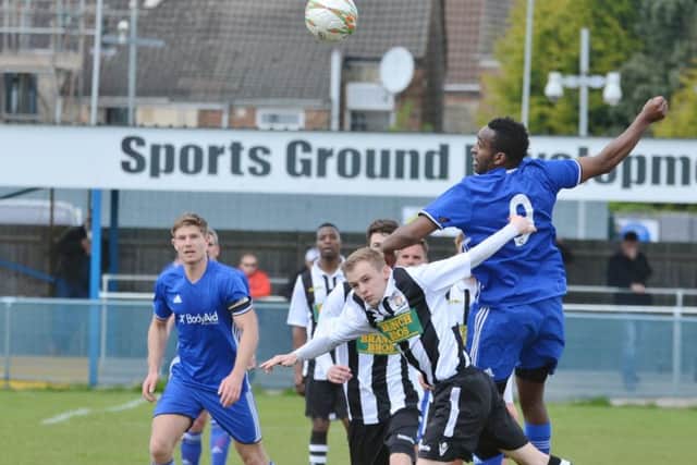 Peterborough Sports striker Avelino Vieira wins a header against Peterborough Northern Star. Photo: David Lowndes.