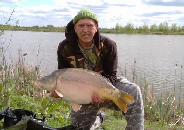 Dave Pearson with a fine 20lb plus carp taken from the Lapwing Pool at Float Fish Farm