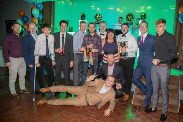 Members of the Islanders team celebrate with owner Jo Lane and the two trophies they have collected this season. Picture: Tom Scott