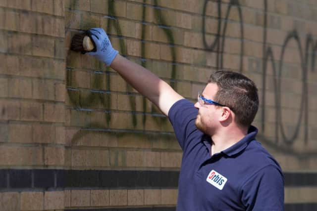 An Orbis worker cleans off Racist Graffiti sprayed on Currys PC World building,
Boulevard Retail Park., Peterborough
19/04/2017. 
Picture by Terry Harris. THA