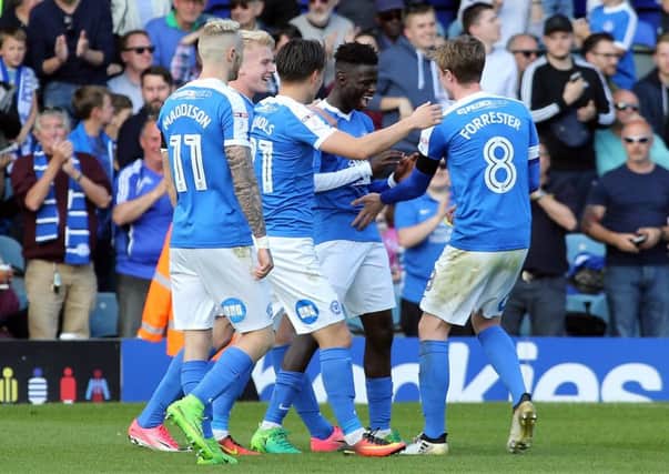 Leo Da Silva Lopes is mobbed by Posh team-mates after his second goal against Bristol Rovers. Photo: Joe Dent/theposh.com.