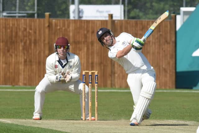 Lewis Bruce of Peterborough Town hits out during an innings of 34 against Wollaston. Photo: David Lowndes.