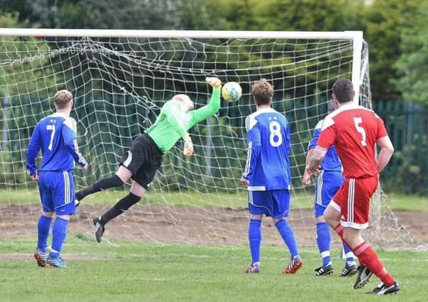 Carl Bird (5) watches his deflected shot win the game for Peterborough Sports Reserves against Moulton Harrox. Photo: David Lowndes.