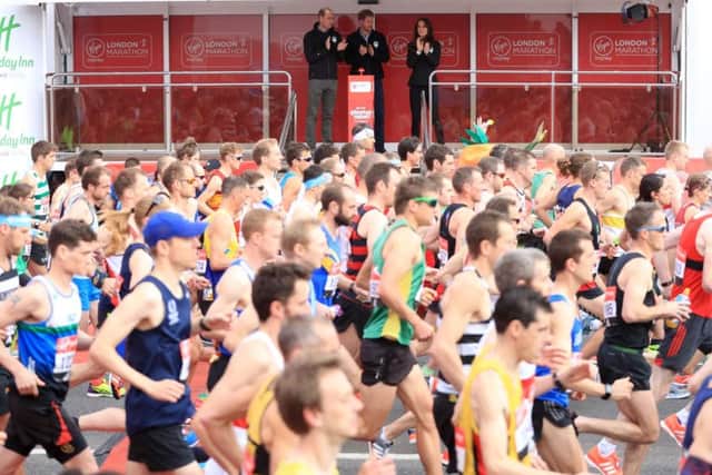 The Duke of Cambridge (left), Prince Harry (right) and the Duchess of Cambridge watch the runners cross at the start line of the Virgin Money London Marathon. Picture: Adam Davy/PA Wire
