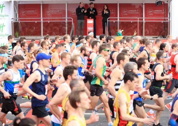 The Duke of Cambridge (left), Prince Harry (right) and the Duchess of Cambridge watch the runners cross at the start line of the Virgin Money London Marathon. Picture: Adam Davy/PA Wire