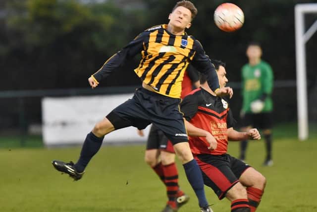 Lewis McManus (stripes) scored for Bretton North End against Whittlesey Athletic B.