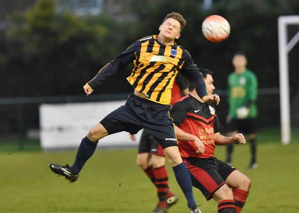 Lewis McManus (stripes) scored for Bretton North End against Whittlesey Athletic B.