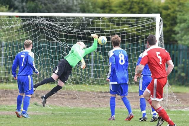 Carl Bird of Peterborough Sports Reserves watches as his deflected free kick finds the back of the Moulton Harrox net. Photo: David Lowndes.