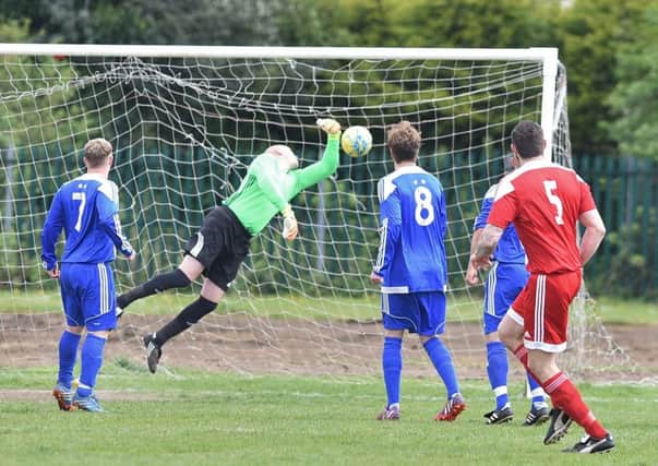Carl Bird of Peterborough Sports Reserves watches as his deflected free kick finds the back of the Moulton Harrox net. Photo: David Lowndes.