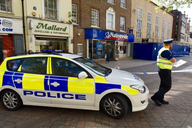 Police investigate an incident in Long Causeway, in Peterborough.