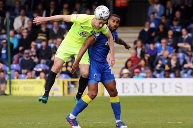 Posh defender Andrew Hughes (yellow) has been in good form.