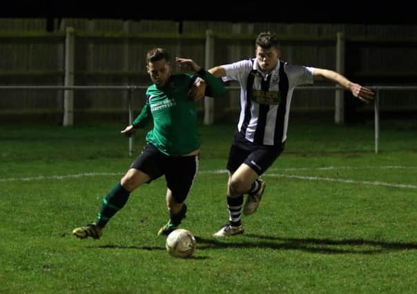 James Hill-Seekings (stripes), pictured playing for Peterborough Northern Star earlier this season, scored a hat-trick for Yaxley against On Chenecks.