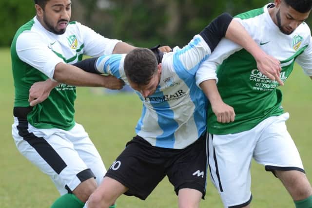 Action from FC Peterborough Reserves' 4-4 draw with Premiair (blue). Photo: David Lowndes.
