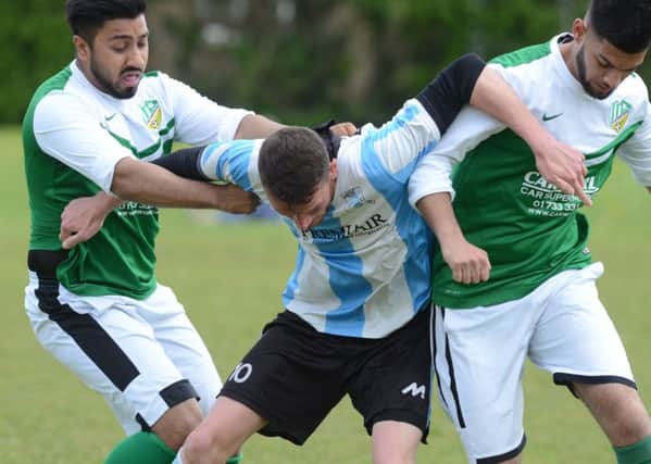 Action from FC Peterborough Reserves' 4-4 draw with Premiair (blue). Photo: David Lowndes.