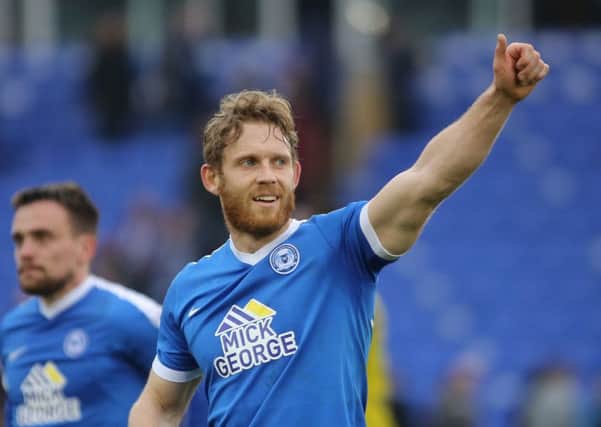 Craig Mackail-Smith acknowledges the Posh crowd after scoring his 100th goal for the club against Oxford.