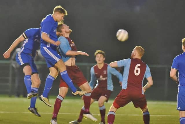 Action from Peterborough Sports' 2-1 win over Deeping Rangers (claret) in the final of the Hinchingbrooke Cup at Yaxley FC. Photo: David Lowndes.