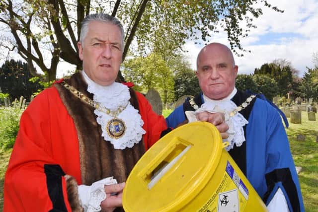 Broadway Cemetery - Mayor Cllr David Sanders and Deputy Mayor Cllr Keith Sharp with a bucket of needles collected by a council worker inside the cemetery EMN-170425-164106009