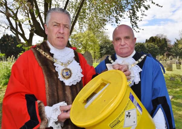 Broadway Cemetery - Mayor Cllr David Sanders and Deputy Mayor Cllr Keith Sharp with a bucket of needles collected by a council worker inside the cemetery EMN-170425-164106009