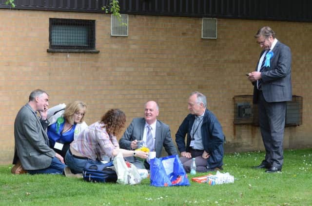 As the tense vote counting goes on inside, the candidates put their political differences aside to have an impromtu picnic on the grass outside