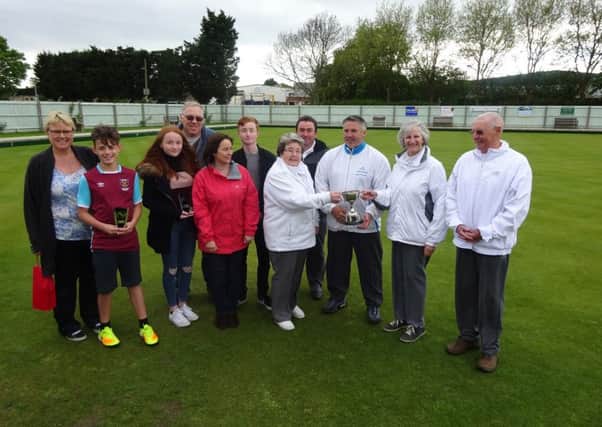 Jessica Phillips and family present the Tony Phillips Memorial trophy to Myra Landsburgh, Michael Humphreys and Peter Leaton following the annual tournament at the City of Peterborough club.