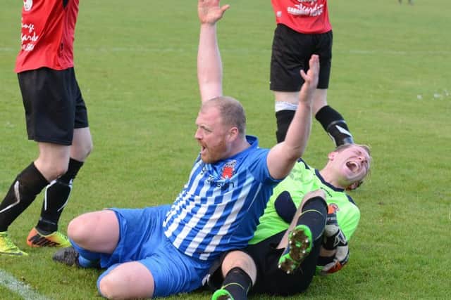 Netherton's impressive goalkeeper Ross Ingram is in paid after a strong challenge. Photo: David Lowndes.