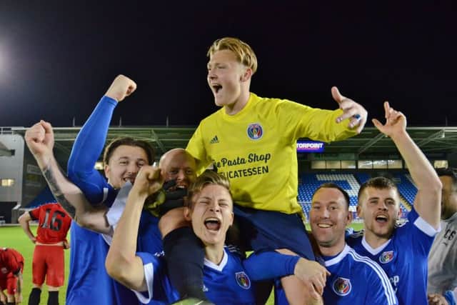 ICA goalkeeper Adam Mills is hoisted high by his team-mates after scoring the winning penalty. Photo: David Lowndes.