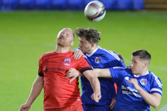 Action from the PFA Senior Cup Final between ICA Sports (blue) and Pinchbeck United. Photo: David Lowndes.