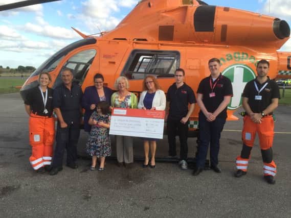 The BRoW4 team handing over more than Â£1,700 to Magpas following the 2016 event