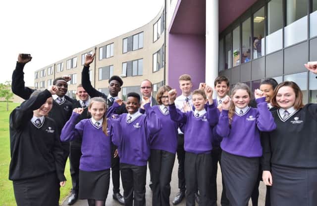 Stanground Academy principal James Scarrott with some of his students celebrating a Good OFSTED EMN-170516-134453009