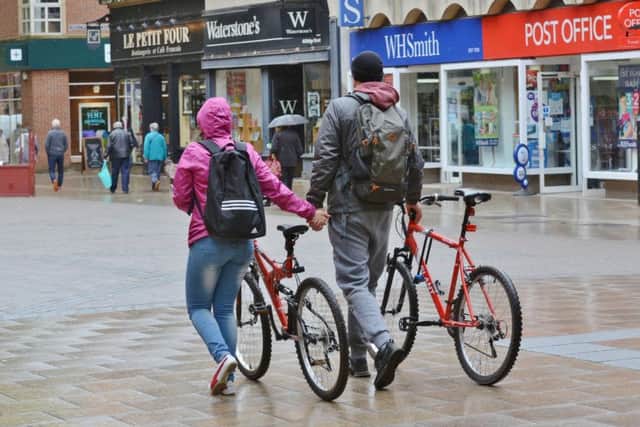 Cyclists walking their bikes down Bridge Street
