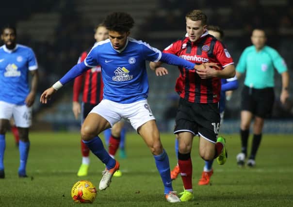 Lee Angol of Peterborough United in action with Bryn Morris of Shrewsbury Town. Picture: Joe Dent