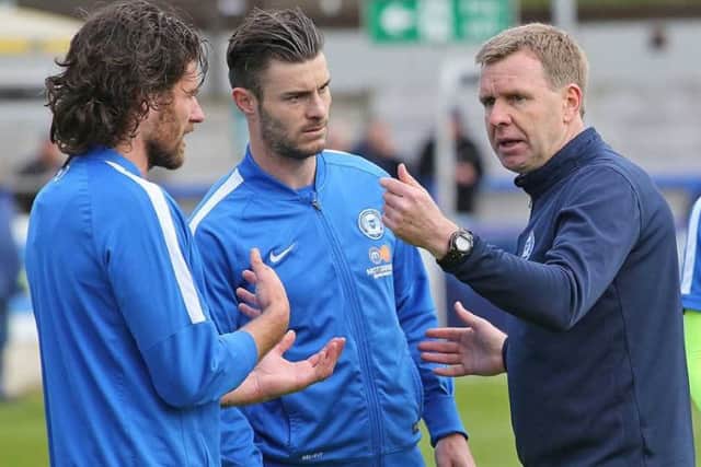 David Oldfield passes on instructions to the players. Photo: Joe Dent/Posh