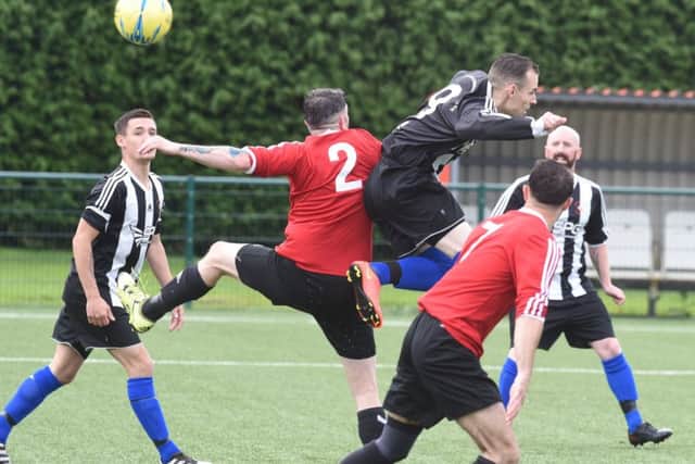 Action from the Division Two play-off final between Tydd St Mary (red) and Langtoft United Reserves. Photo: David Lowndes.