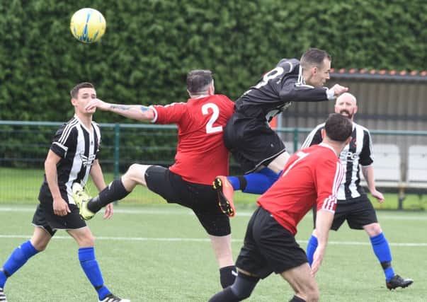 Action from the Division Two play-off final between Tydd St Mary (red) and Langtoft United Reserves. Photo: David Lowndes.