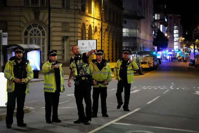 Police near the scene of the explosion in Manchester yesterday.