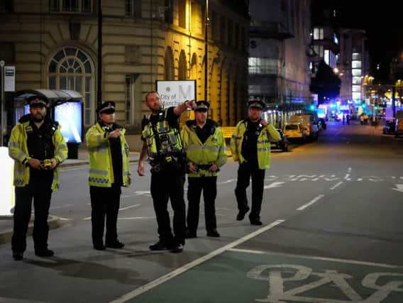 Police near the scene of the explosion in Manchester yesterday.