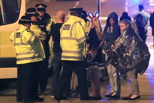 Police at the scene of the attack in Manchester last night