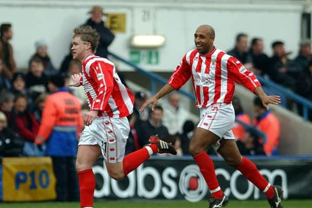 Grant McCann (left) celebrates a goal for Cheltenham.