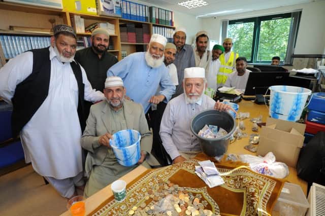 Friday prayers at  Faizan-e-Madina Mosque -- collections for mosque and Manchester Fund.Mohammad Hussain and Abdul Choudhury with committee members of the mosque counting collections EMN-170526-155319009