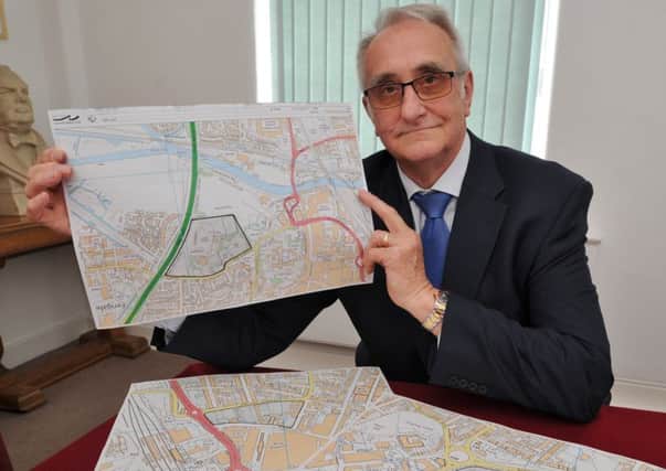 Peterborough City Council leader Cllr John Holdich with maps of proposed sites for a Peterborough University campus  EMN-170530-145956009