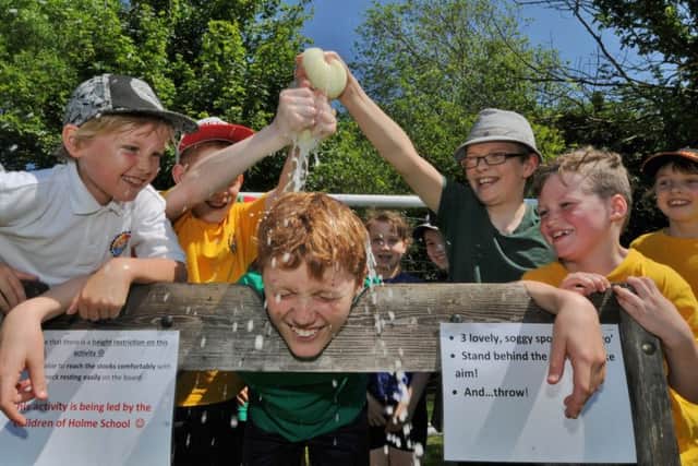 Holme Primary School reward day after a good Ofsted. Burt Papworth in the stocks EMN-170527-161856009