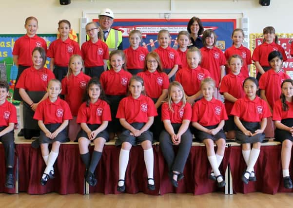 Students at Elsea Park Primary Academy showing off their new Larkfleet-sponsored tee shirts with Joe Yardley from the company and Miss Davies from the school in the back row.
