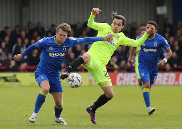 Callum Chettle of Peterborough United in action with Jake Reeves of AFC Wimbledon. Picture: Joe Dent