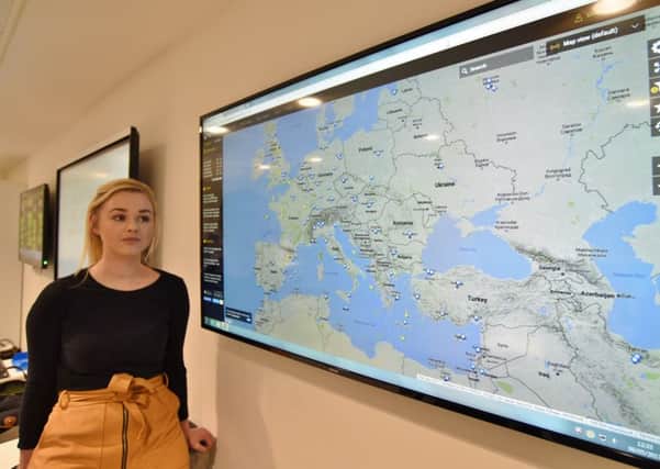 Senior duty manager Emily Gibson surveys a map showing locations of Thomas Cook flights at the Thomas Cook Duty Office in Peterborough.    EMN-170905-233623009