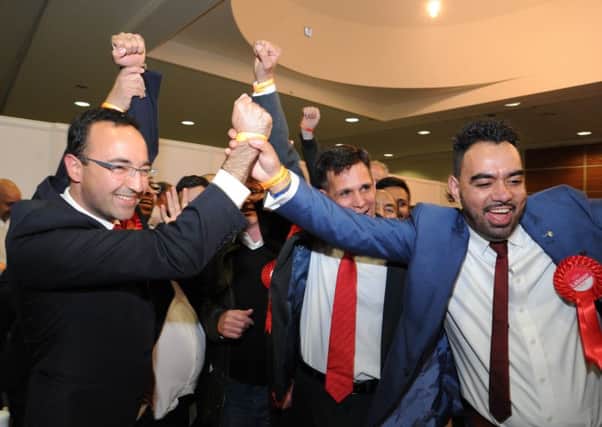 Labour's Matthew Mahabadi celebrates with supporters after taking the East Ward seat in the Peterborough City Council by-election.