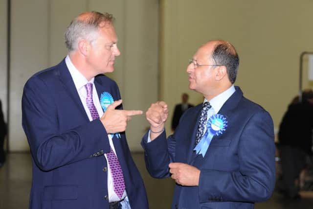 Stewart Jackson, left, discusses the vote with Shailesh Vara, right