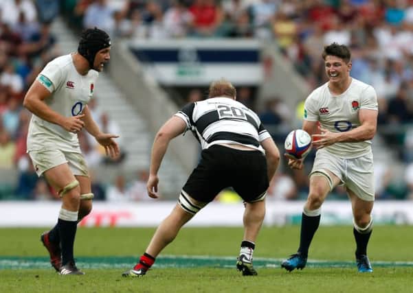 England's Tom Curry (right) in action during the Old Mutal Wealth Cup match against the Barbarians at Twickenham. Picture: Paul Harding/PA Wire.