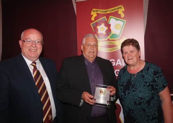 Malcolm Smith and his wife with Northants FA business manager Gary Biddulph (left). Picture: RWT Photography
