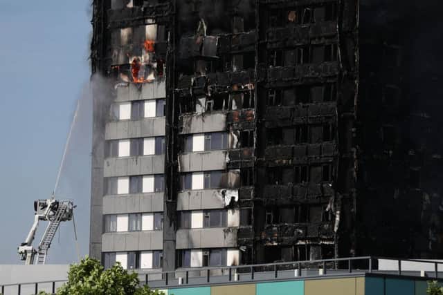 Smoke billows from a fire that has engulfed the 24-storey Grenfell Tower in west London.  PRESS ASSOCIATION Photo.